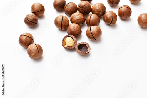 a scattering of macadamia nuts on a white background