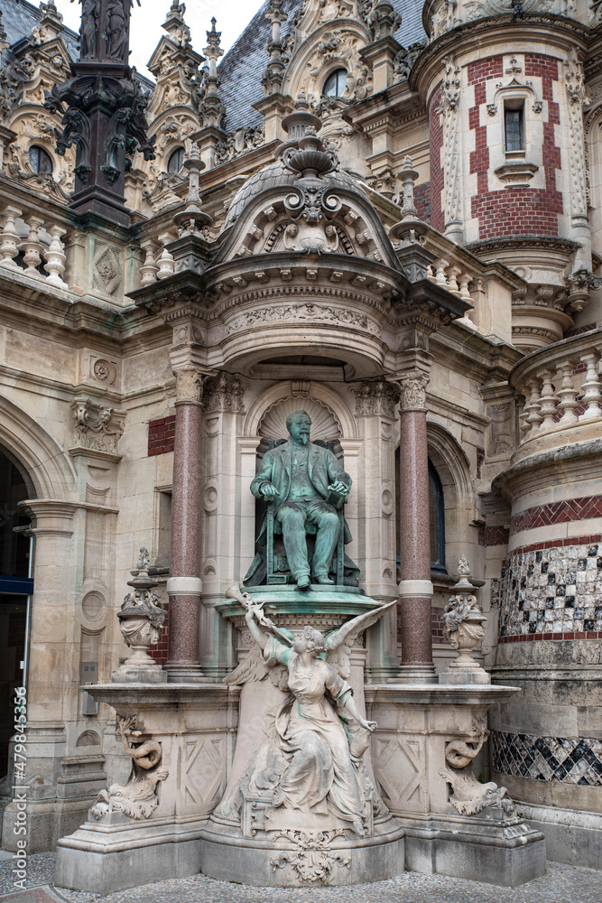 Detail of the exterior architecture of a gothic monastery with a statue in Fécamp, France