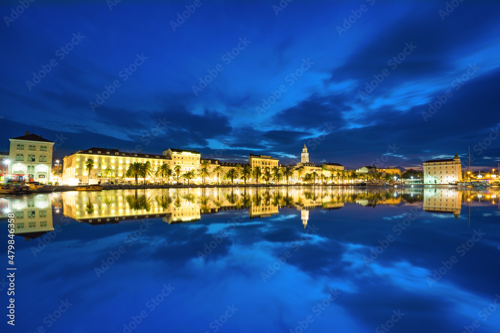 Riva promenade with Diocletian Palace with reflection at dawn. Split, Croatia