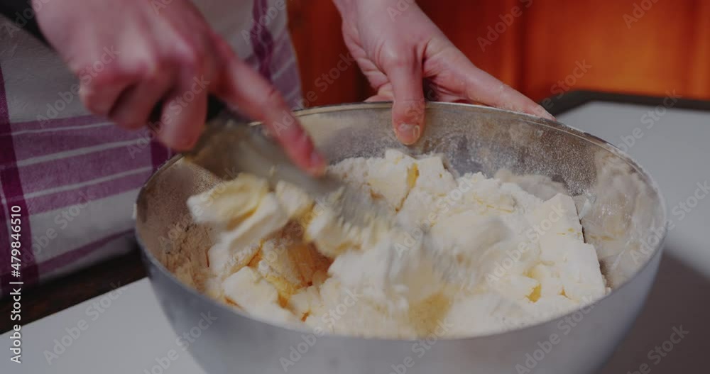 Woman Working in the Kitchen mixing flour and butter in bowl., Baking Croissants and Cookies.