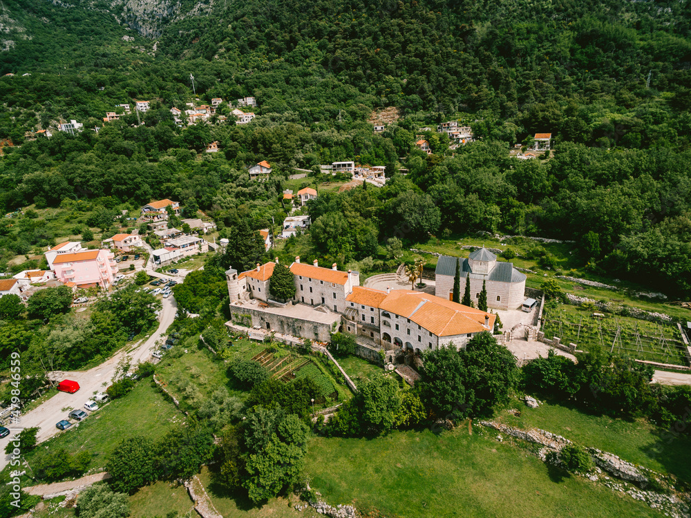 Podmaine monastery surrounded by green trees. Top view