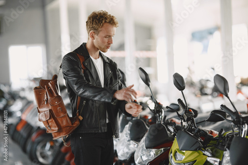 Handsome man choosing a motorcycle to buy