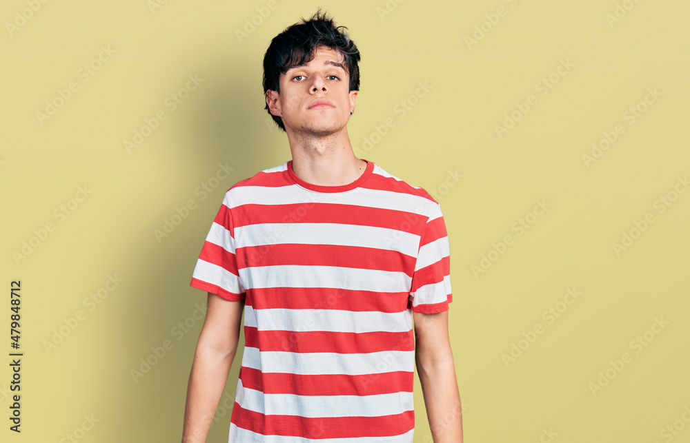 custom made wallpaper toronto digitalHandsome hipster young man wearing casual striped t shirt relaxed with serious expression on face. simple and natural looking at the camera.