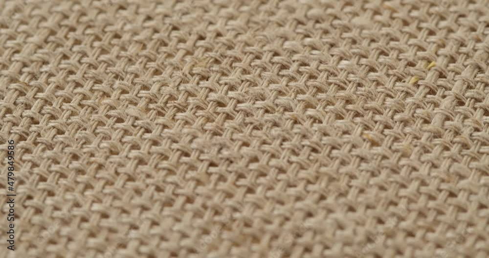 Beige woolen fabric close-up. Macro shooting of soft and warm knitted cloth. Woolen clothing, abstract background. Tailoring and sewing concept. Material sample. Beige woolen fabric close-up. Macro shooting of soft and warm knitted cloth. Woolen clothing, abstract background. Tailoring and sewing concept. Material sample.