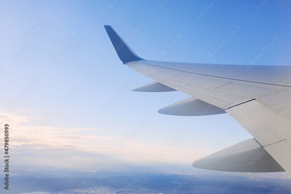 Wing of airplane in the sky. Travel and transportation concept Wing of airplane in the sky. Travel and transportation concept