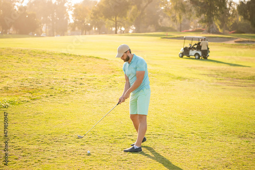 young man playing golf game on green grass, sports
