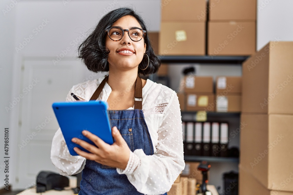 Young latin woman ecommerce business worker using touchpad at office Young latin woman ecommerce business worker using touchpad at office