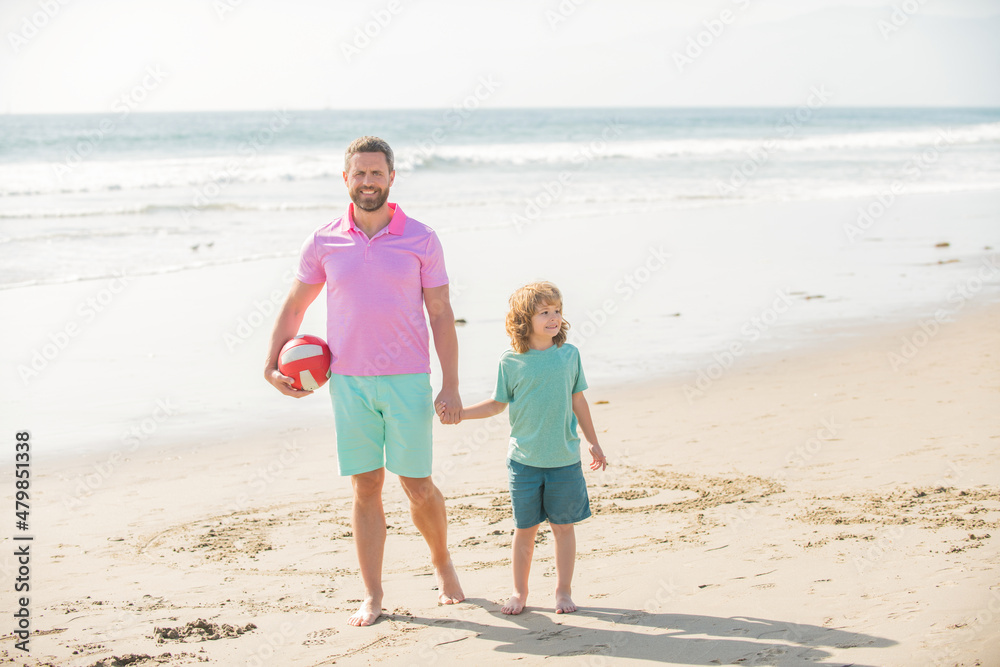 kid and dad walking on beach in summer vacation holding ball, summer