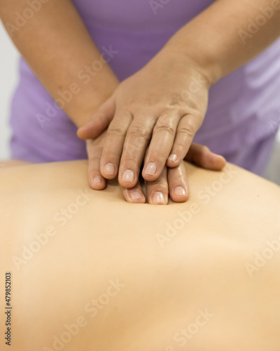 Indirect close-chest cardiac massage. Massager doctor hands closeup. Cosmetologist procedure acupressure. 
