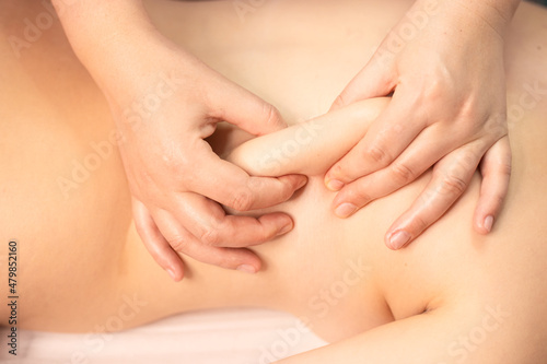 Massage closeup, cosmetologist procedure, acupressure. Backrub, back pain release close up. Fat-dissolving massage and exfoliation. 