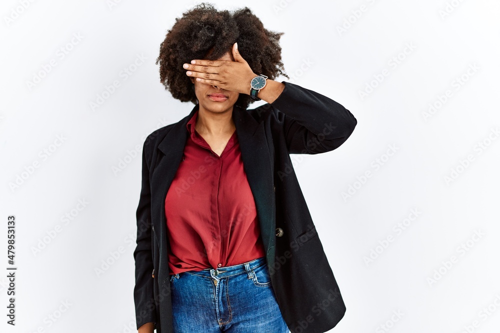 African american woman with afro hair wearing business jacket and glasses covering eyes with hand, looking serious and sad. sightless, hiding and rejection concept African american woman with afro hair wearing business jacket and glasses covering eyes with hand, looking serious and sad. sightless, hiding and rejection concept