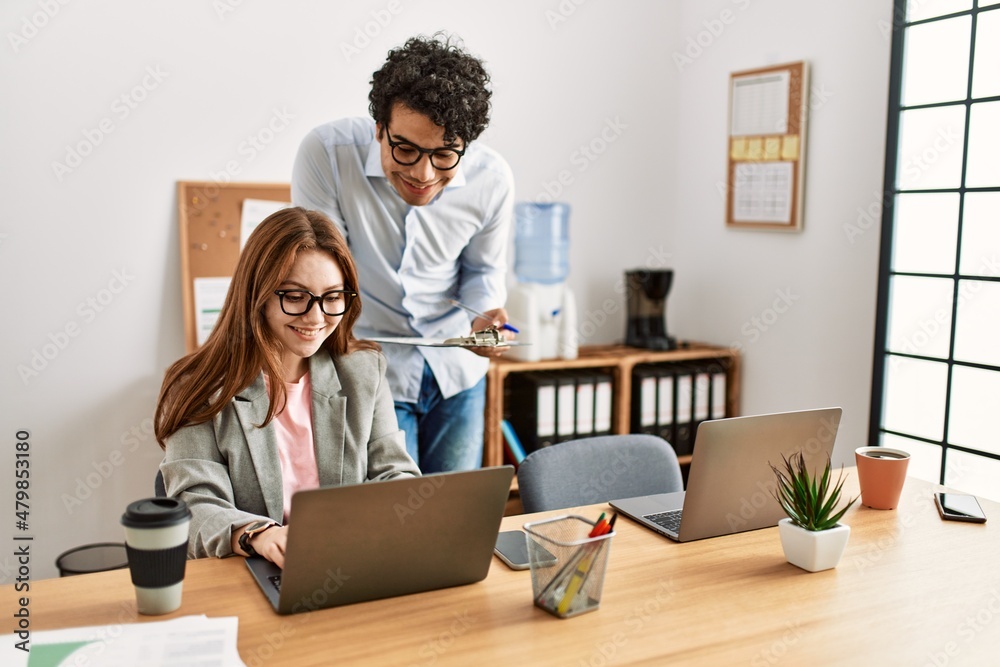 Two business workers smiling happy working at the office. Two business workers smiling happy working at the office.