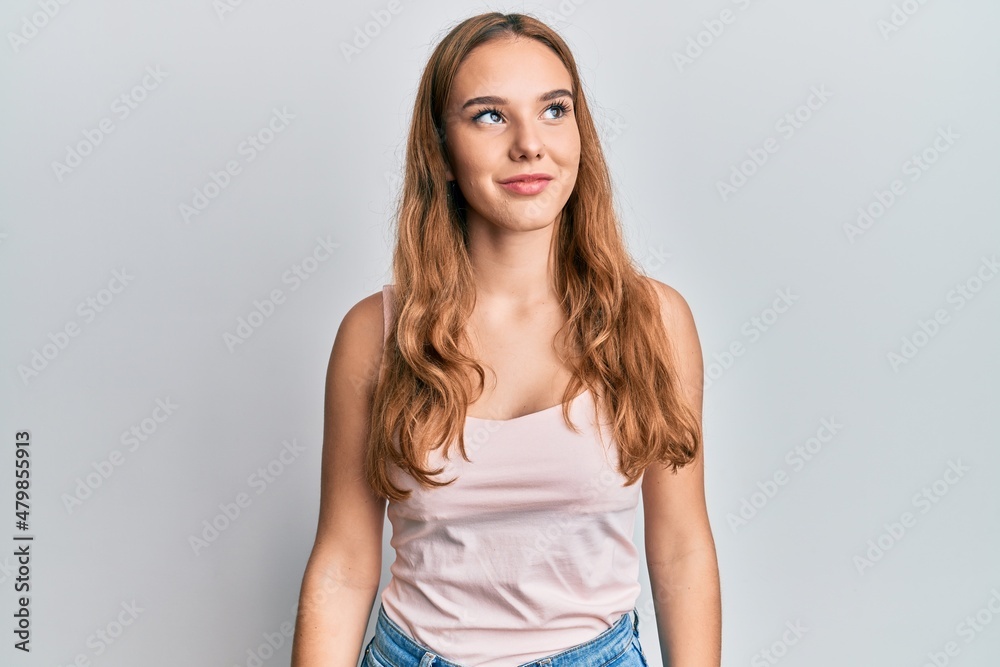 Young blonde woman wearing casual style with sleeveless shirt looking to side, relax profile pose with natural face and confident smile. Young blonde woman wearing casual style with sleeveless shirt looking to side, relax profile pose with natural face and confident smile.