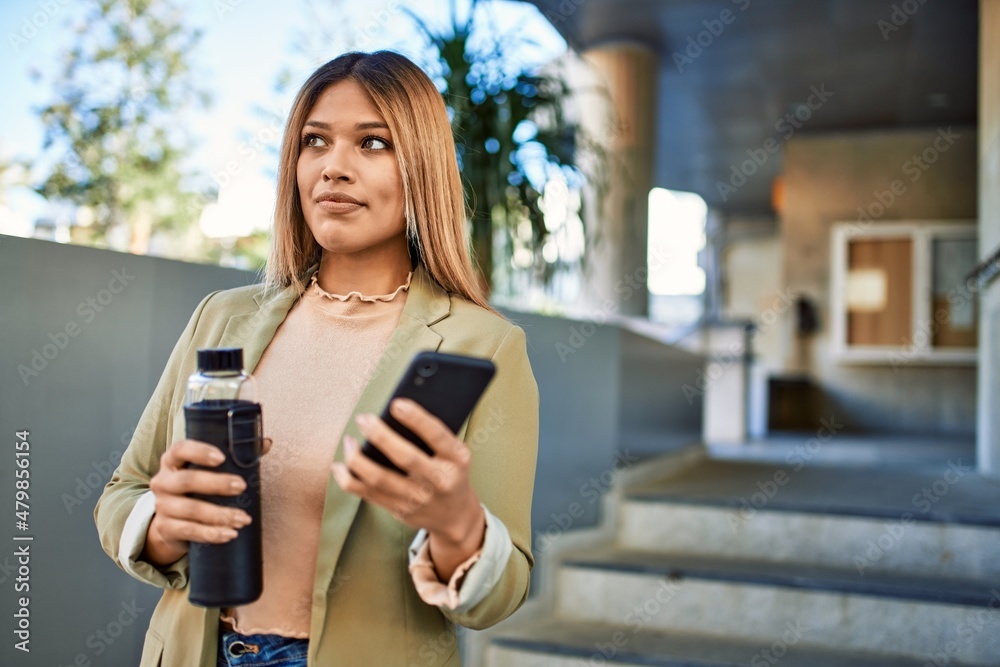 Young latin woman smiling confident using smartphone at street Young latin woman smiling confident using smartphone at street