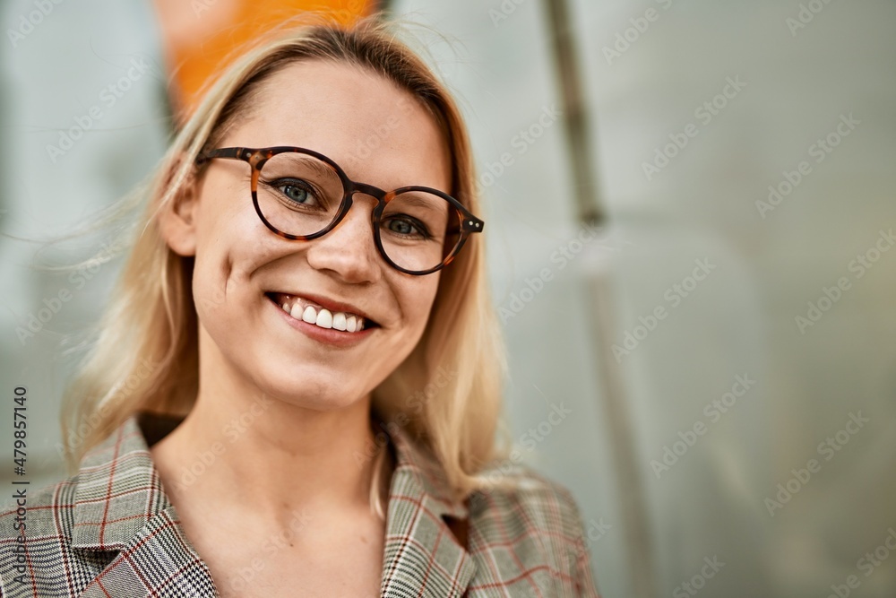 Young blonde businesswoman smiling happy standing at the city. Young blonde businesswoman smiling happy standing at the city.