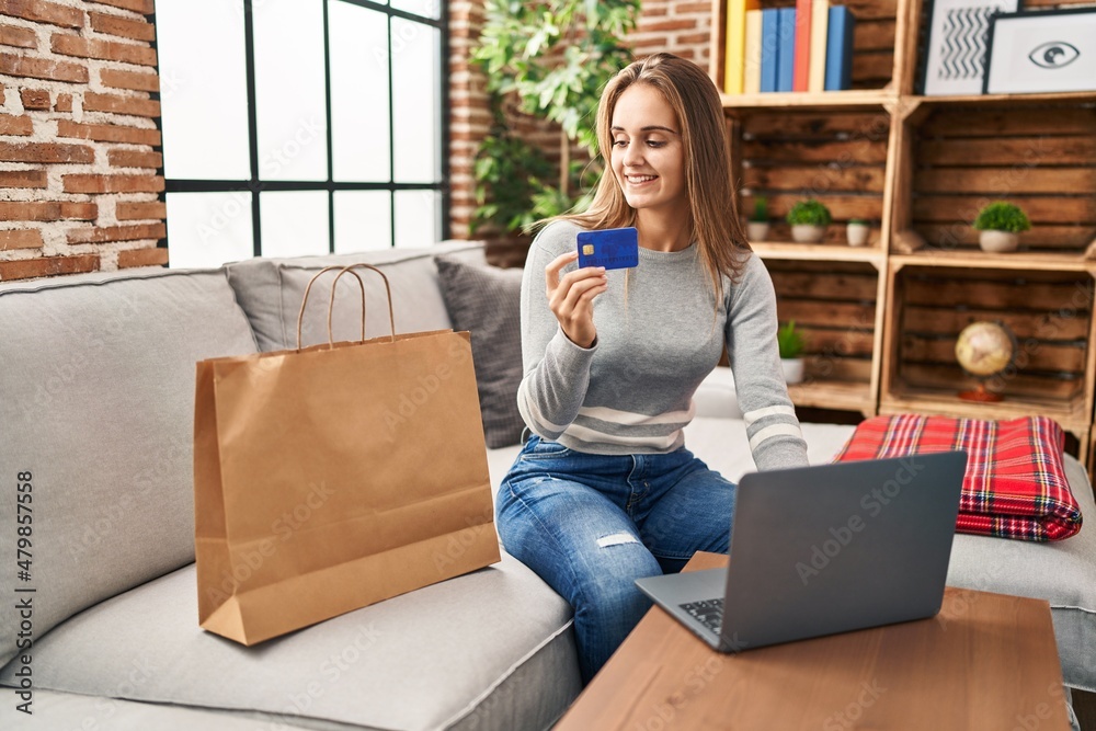 Fototapeta premium Young blonde woman smiling confident shopping online at home