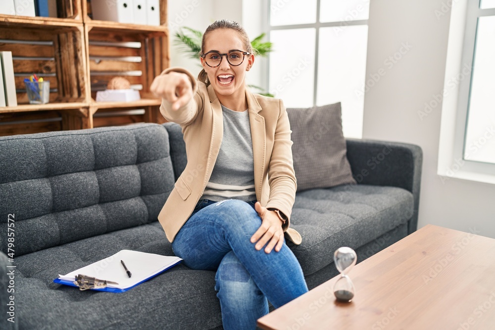 Young woman working at consultation office pointing displeased and frustrated to the camera, angry and furious with you Young woman working at consultation office pointing displeased and frustrated to the camera, angry and furious with you