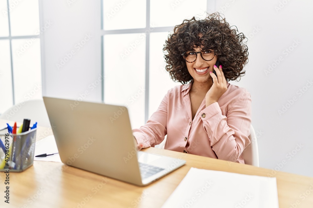 Young middle east businesswoman talking on the smartphone working at the office.