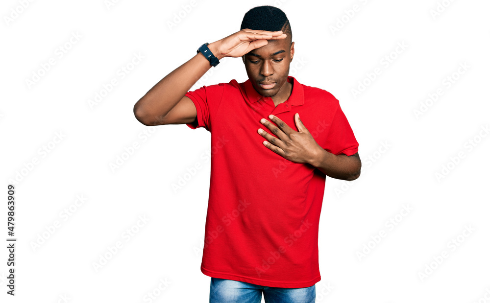 Young african american man wearing casual red t shirt touching forehead for illness and fever, flu and cold, virus sick