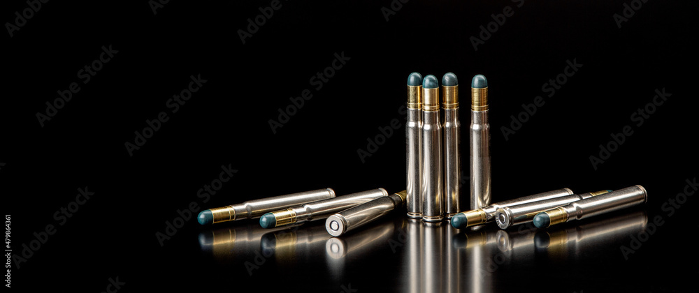 Fototapeta premium Bullet isolated on black background with reflexion. Rifle bullets close-up on black back. Cartridges for rifle and carbine on a black.