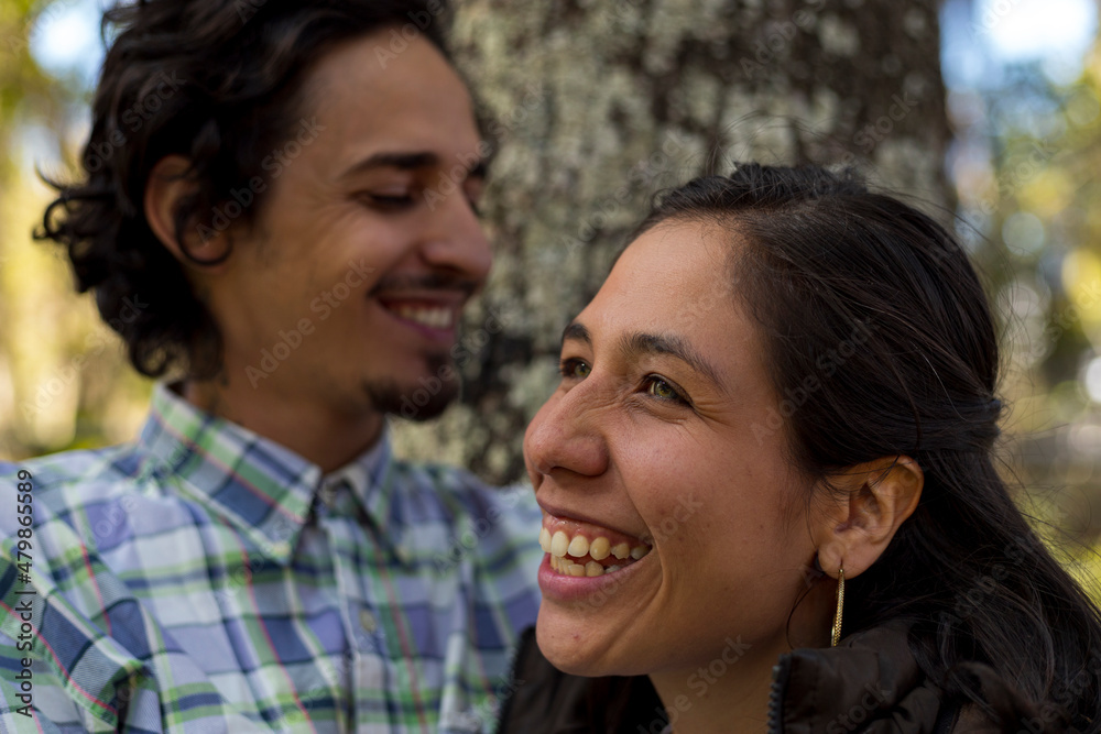 Young latin couple (28) smile happily. Selective focus on the woman's face. Valentine's Day concept, couples and friendships. Young latin couple (28) smile happily. Selective focus on the woman's face. Valentine's Day concept, couples and friendships.