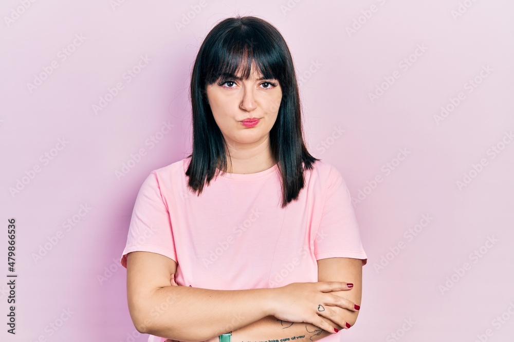 Young hispanic woman wearing casual clothes skeptic and nervous, disapproving expression on face with crossed arms. negative person. Young hispanic woman wearing casual clothes skeptic and nervous, disapproving expression on face with crossed arms. negative person.
