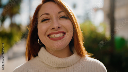 Young redhead woman smiling confident standing at park