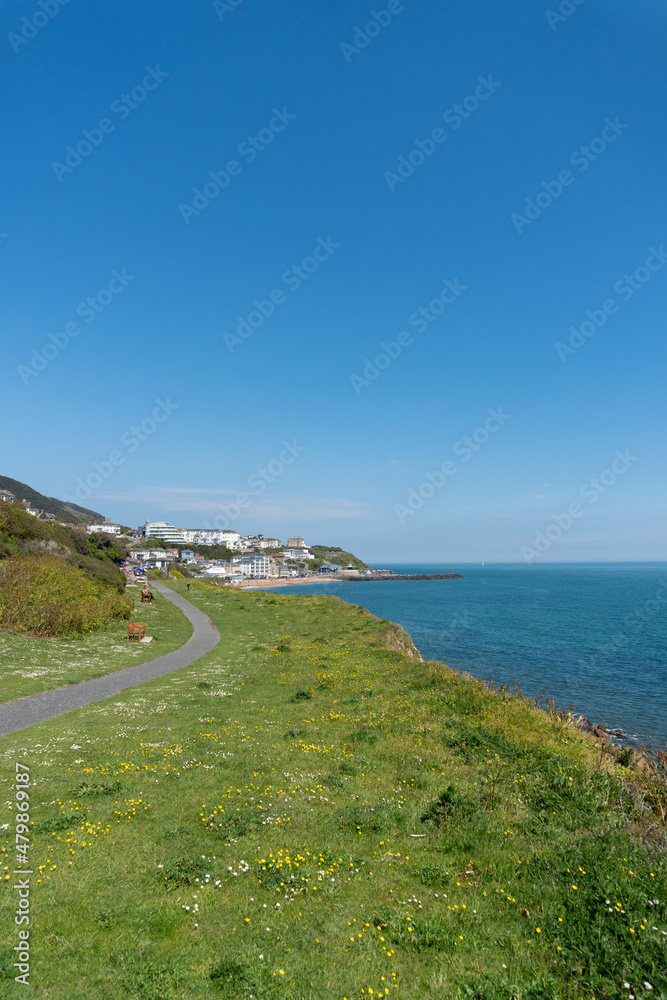 Far away view of Ventnor from walking path on cliff tops along shore, Isle of Wight, United Kingdom