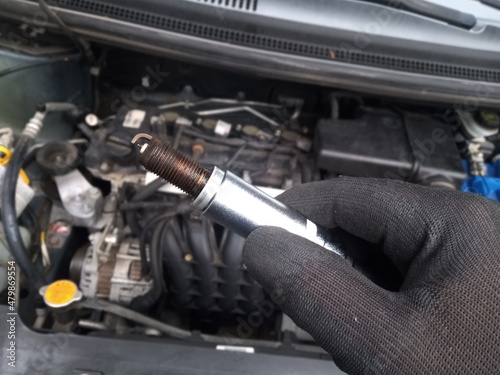 changing of spark plugs - maintenance and repair work at a car