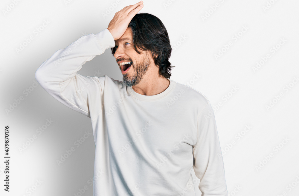 Middle age caucasian man wearing casual clothes smiling confident touching hair with hand up gesture, posing attractive and fashionable Middle age caucasian man wearing casual clothes smiling confident touching hair with hand up gesture, posing attractive and fashionable