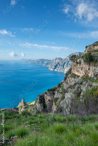 View of the Sorrentine Peninsula and Capri along the Amalfi Coast of Italy, with Tyrhennian Sea under blue skies and clouds