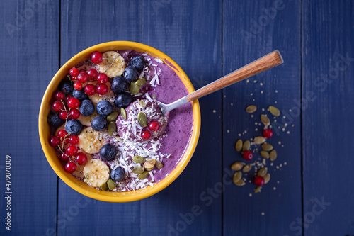 Overhead view of healthy blueberry smoothie bowl with copy space photo