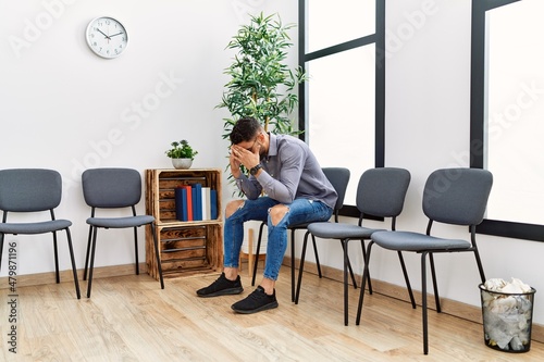 Young arab man desperate sitting on chair at waiting room