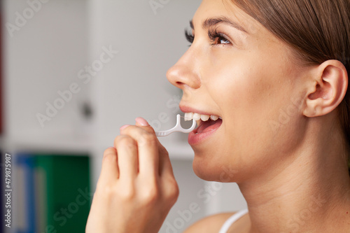 Smiling women use dental floss white healthy teeth.