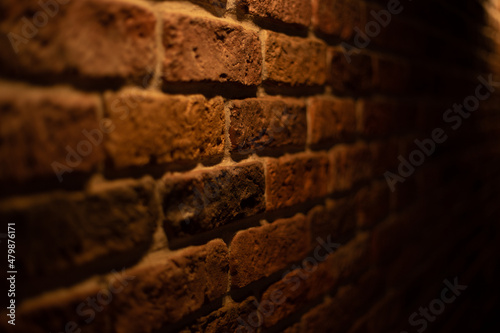 Brick wall illuminated by warm light from a lamp