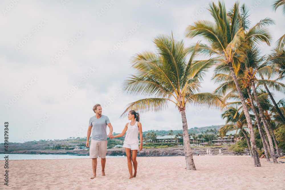 Lanai Hawaii beach vacation travel holidays getaway. Romantic couple on honeymoon walking on Hulopoe Beach on Lanai, Hawaii.