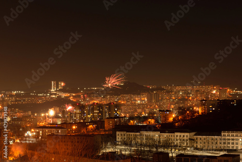 Fireworks in the city at night during New Year celebration. Soft focus background © Rina Mskaya