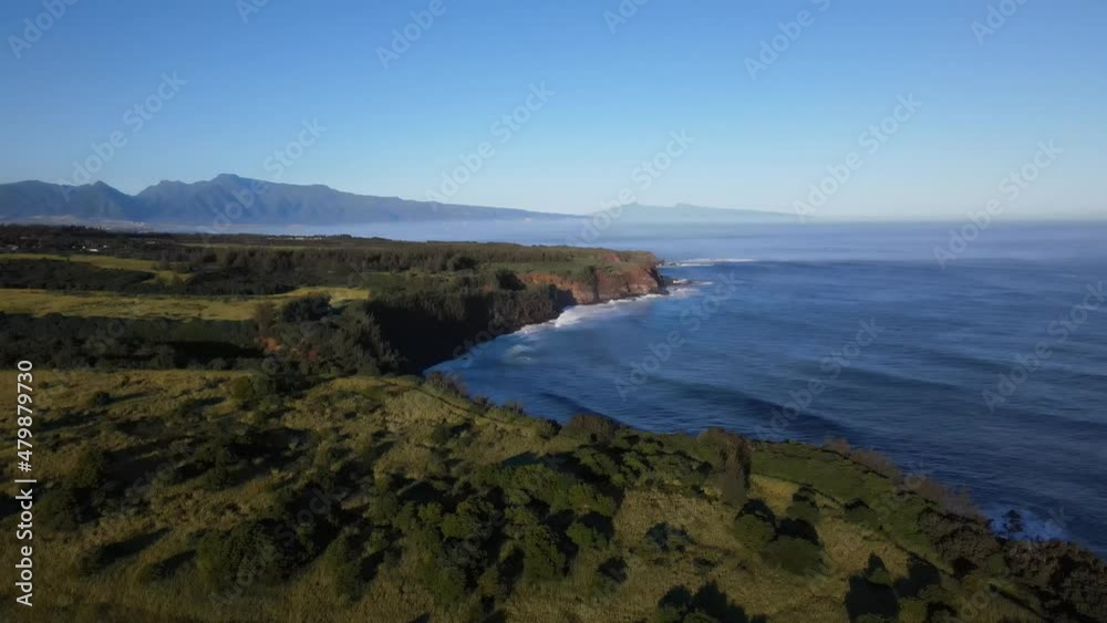 Morning view of North Shore Maui waves and cliffs Morning view of North Shore Maui waves and cliffs