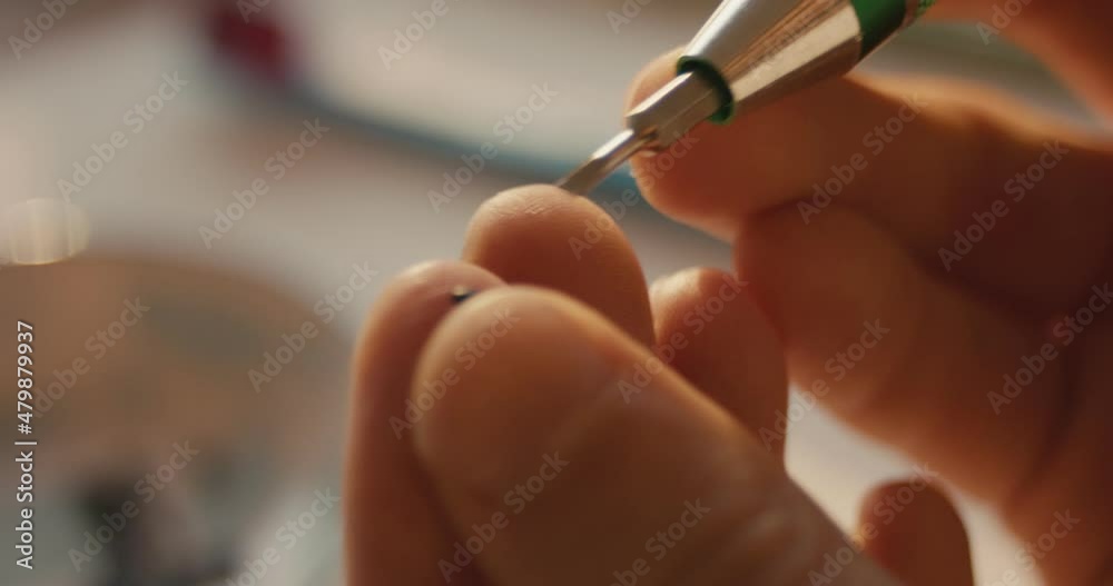 Male hand screwdriver screws a screw assembles photo lens in close up Male hand screwdriver screws a screw assembles photo lens in close up