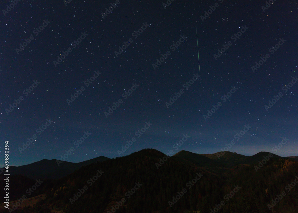 Carpathian mountains at night with shooting star Carpathian mountains at night with shooting star