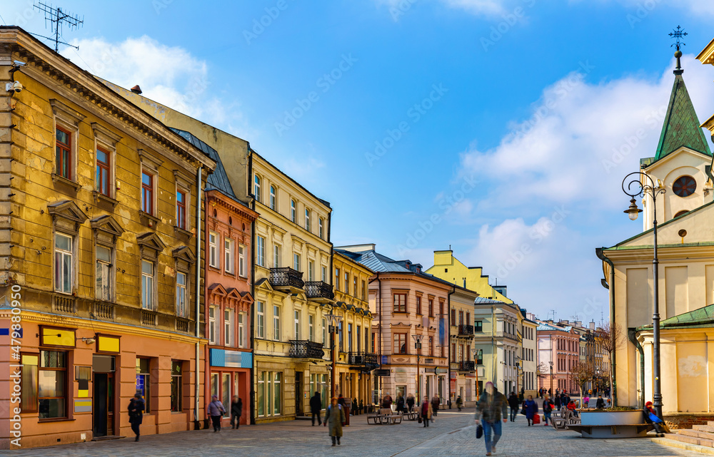 View of traditional colored tenements houses on central streets of Polish city of Lublin in sunny spring day