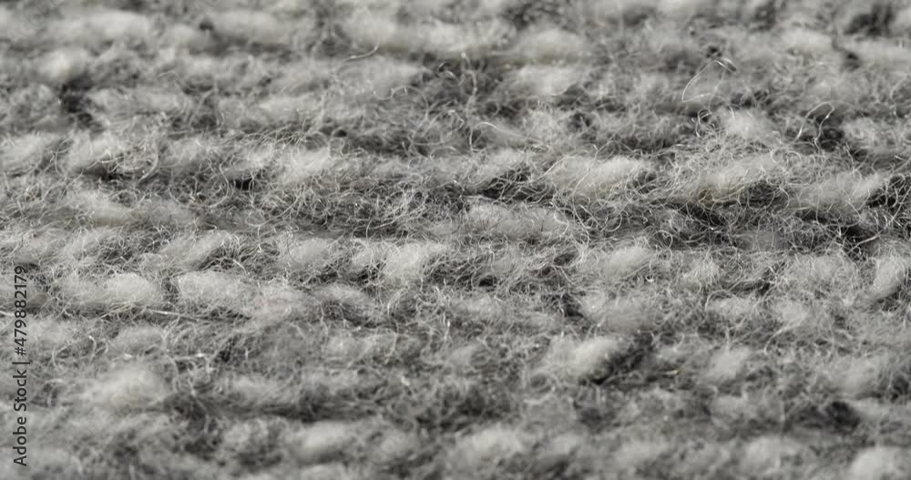 Grey woolen fabric close-up. Macro shooting of soft and warm knitted cloth. Woolen clothing, abstract background. Tailoring and sewing concept. Material sample. Grey woolen fabric close-up. Macro shooting of soft and warm knitted cloth. Woolen clothing, abstract background. Tailoring and sewing concept. Material sample.