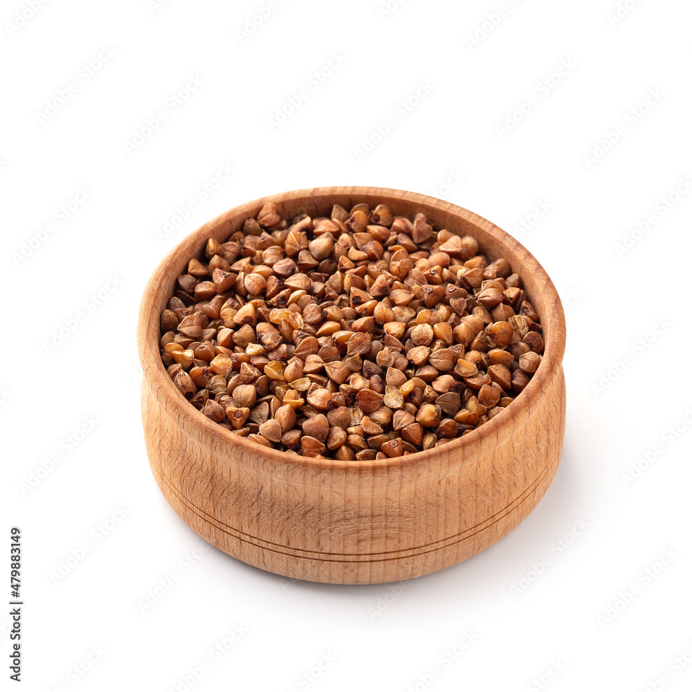 Buckwheat in a wooden cup. White background Buckwheat in a wooden cup. White background