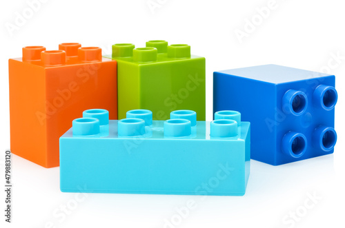 Parts of a child's construction kit made of plastic on a white background. Bright multi-colored constructor for children. Development of thinking and fine motor skills of the child