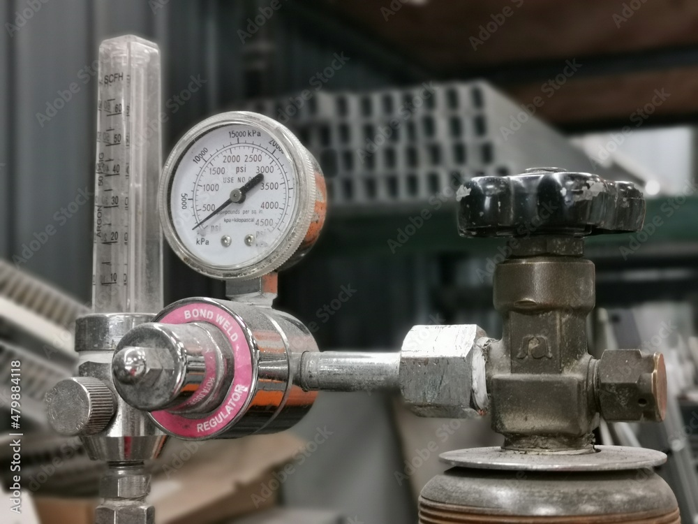 Pressure gauge regulator manometer with blurry background.
