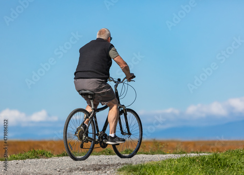 Senior man on cycle ride in countryside in Canada