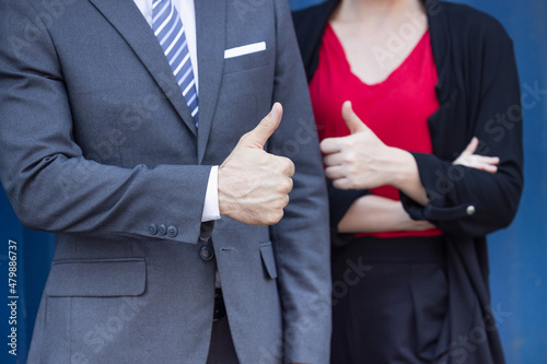 Closeup hand Thumbs up business man and office women for satisfy good job best work concept photo