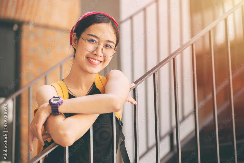 portrait cute university teen girl Thai Asian with glasses happy smile