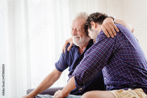 old father elder grateful happy smile and embrace his son at home