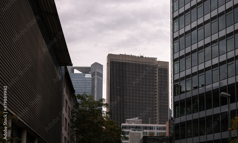 Financial district of Europe in Frankfurt, Germany. Tall skyscraper office buildings photographed in a cloudy day. Business and finance industries. Financial district of Europe in Frankfurt, Germany. Tall skyscraper office buildings photographed in a cloudy day. Business and finance industries.